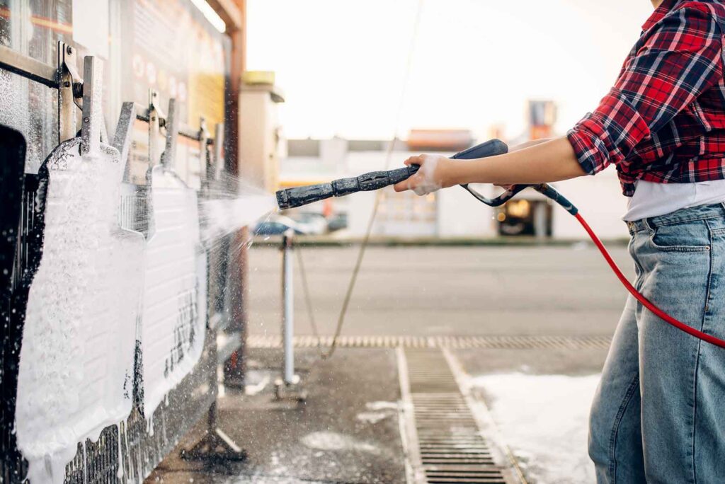 female-person-with-water-gun-cleans-car-mats-URZJMKF.jpg